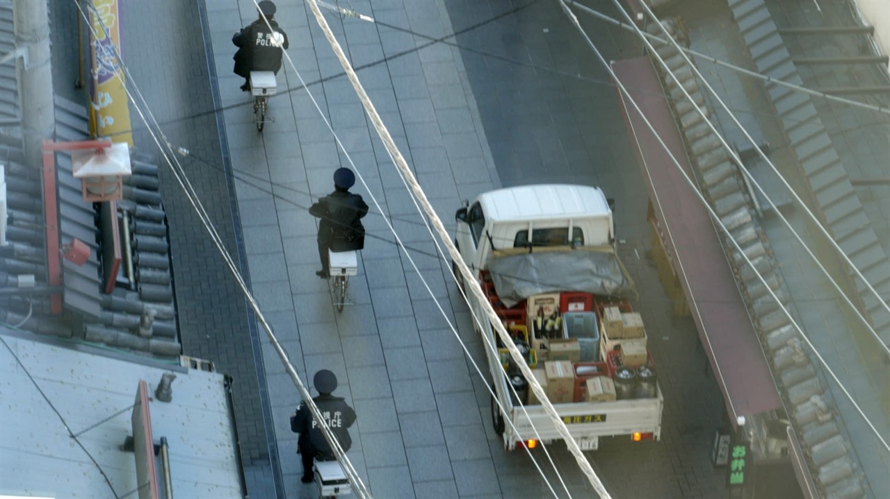 Overhead of a street: Delivery truck & 3 cyclists